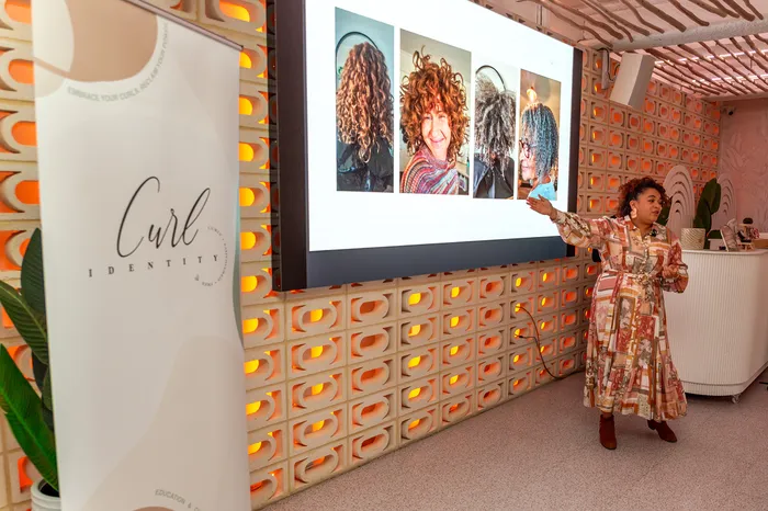 Caroline speaking at the Curls Connection event