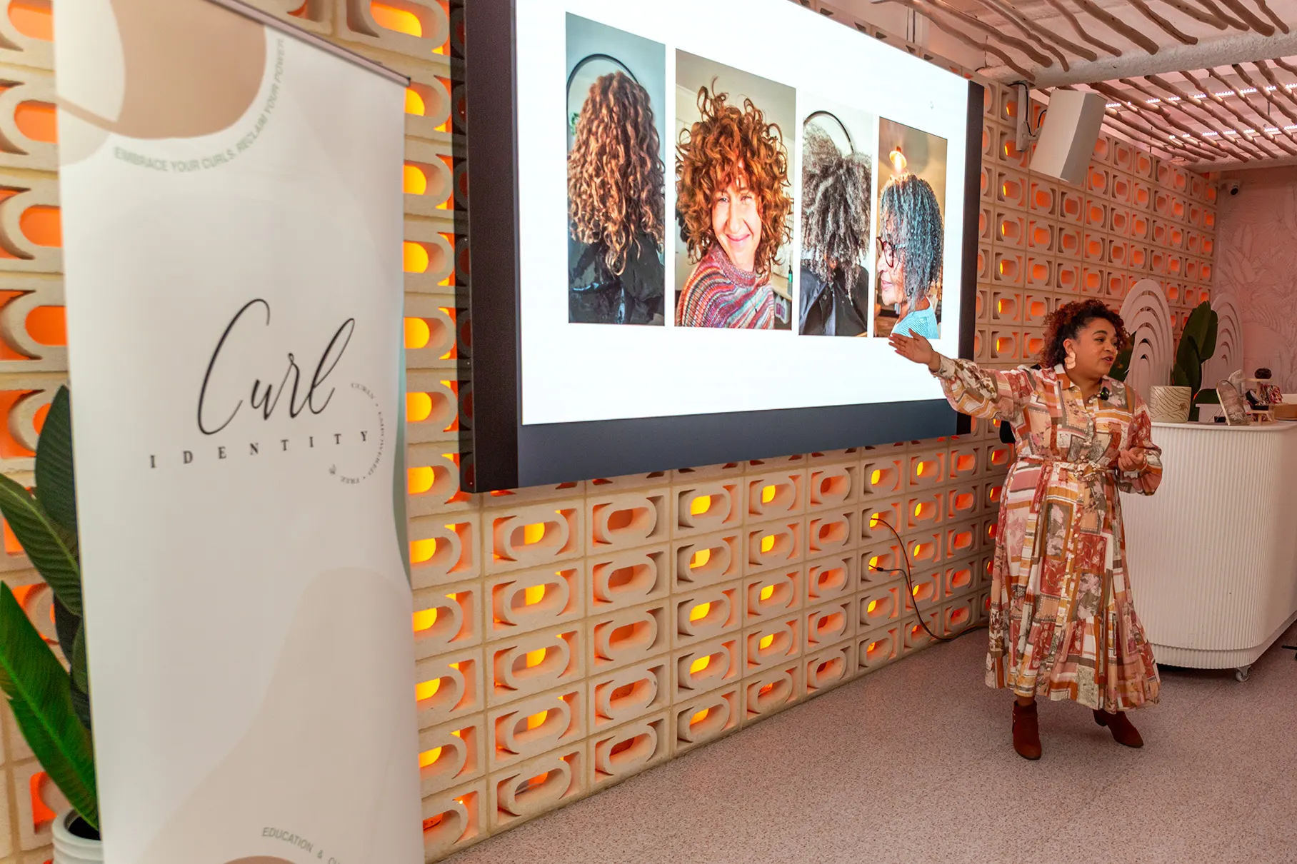 Caroline Smalley speaking to a room at a Curls Connection event